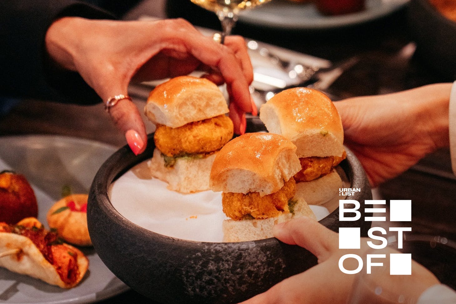 Someone grabs a delicious snack at Cassia, one of the best Indian restaurants in Auckland.